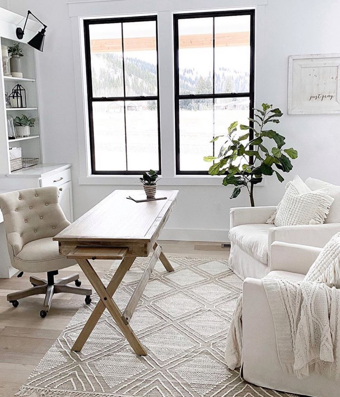 Farmhouse office with bright windows and library shelves