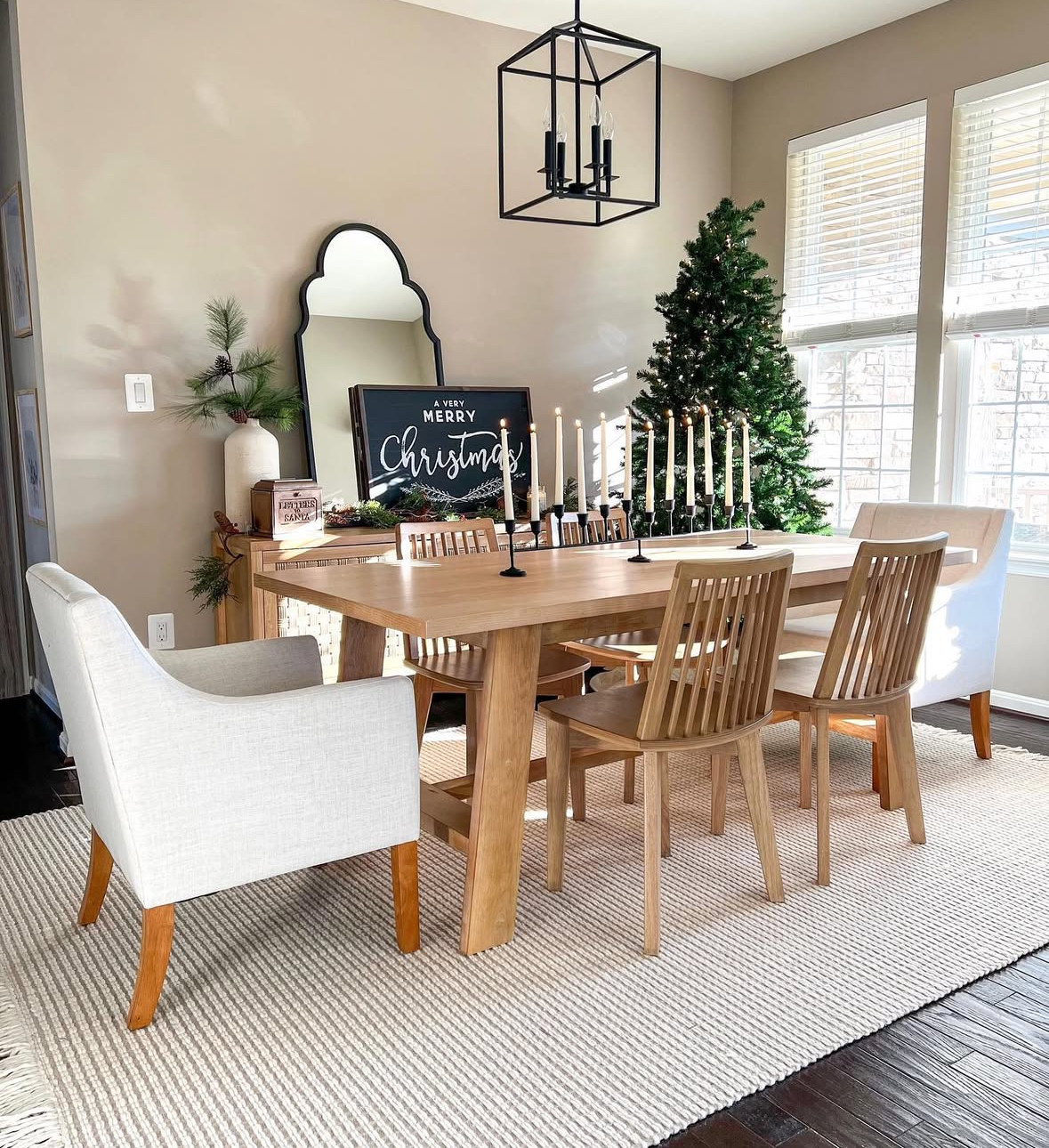 Scandi-inspired space with candleline and natural wood, ideal for Christmas dining room table ideas.