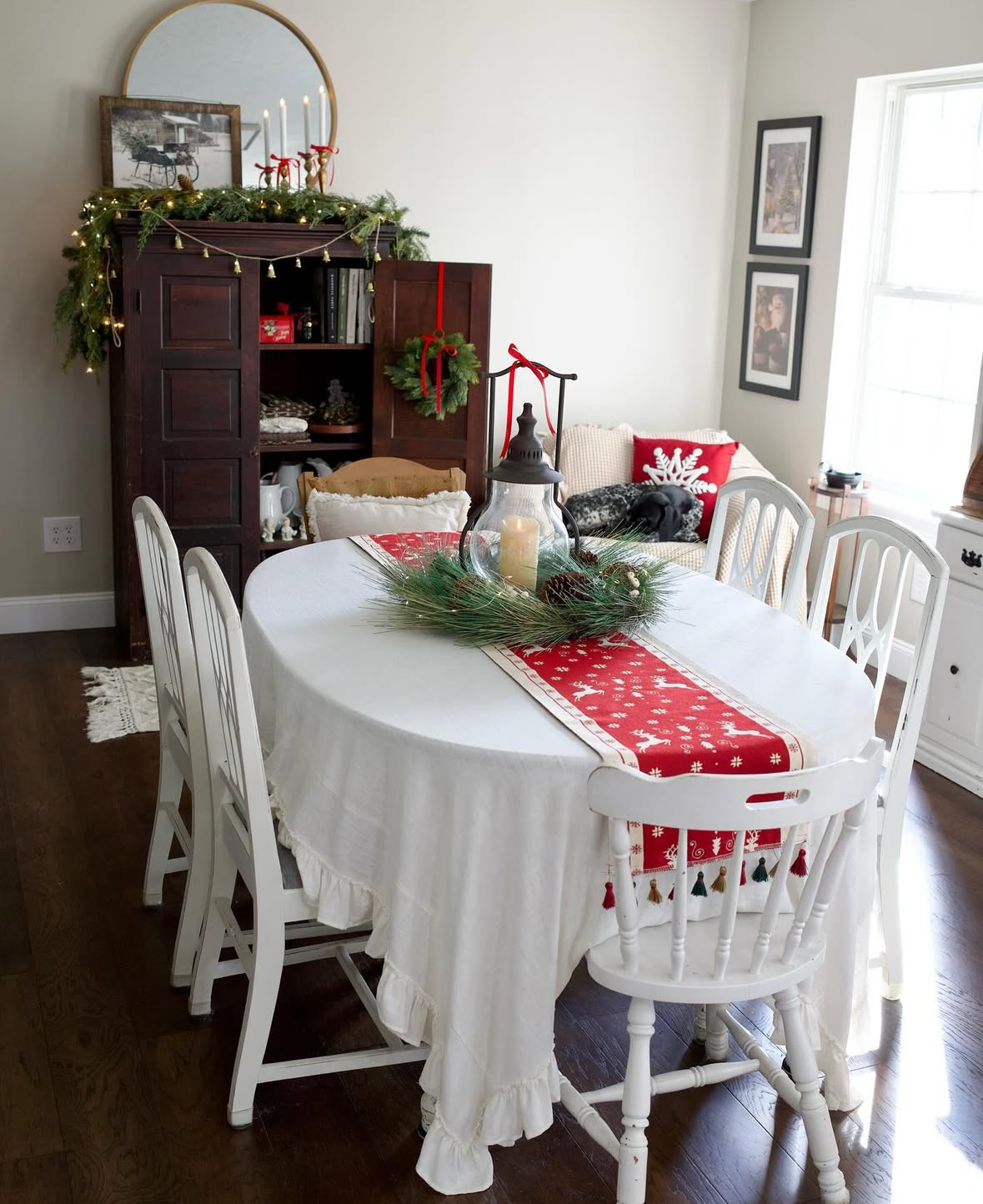 Cottage nook with ruffled cloth, lantern centerpiece, and twinkle lights—sweet Christmas decoration ideas for dining room.