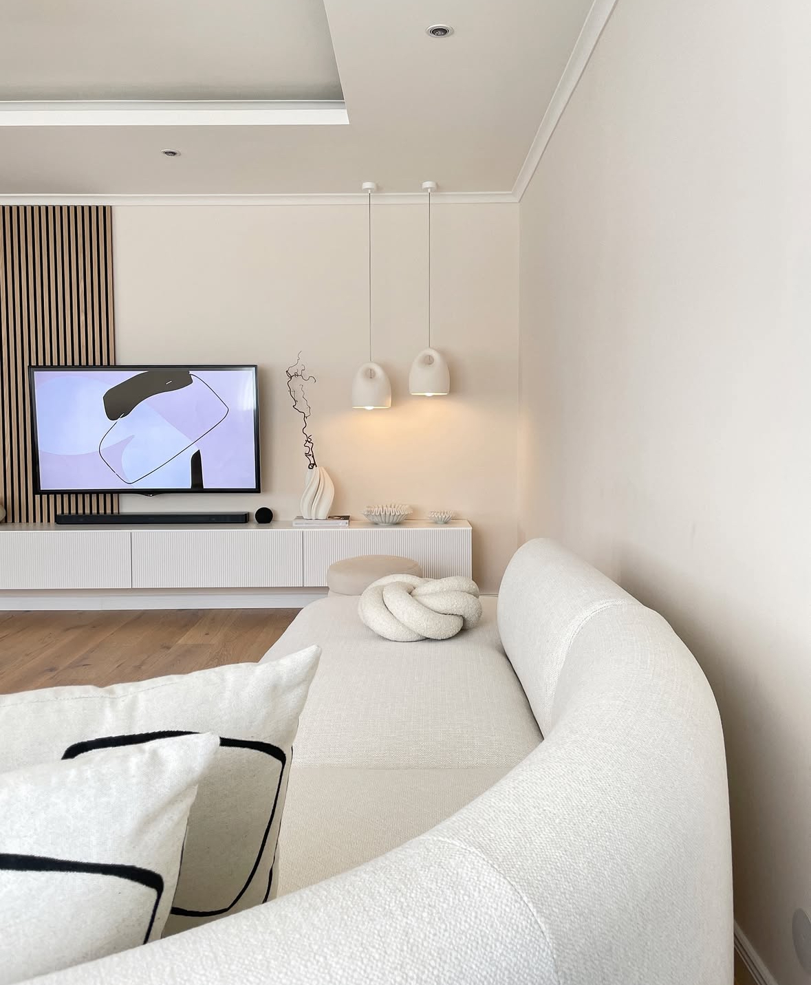 Japandi living room with a white console and slat panel accent wall