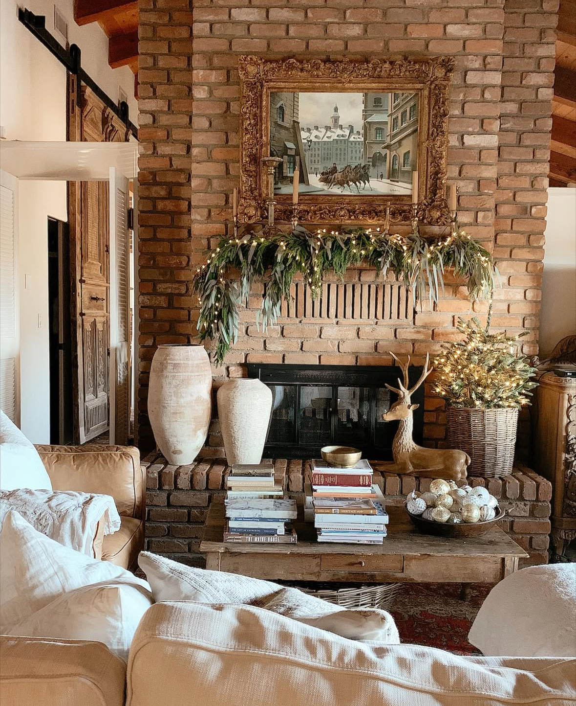 Red brick fireplace decorated with classic green garland