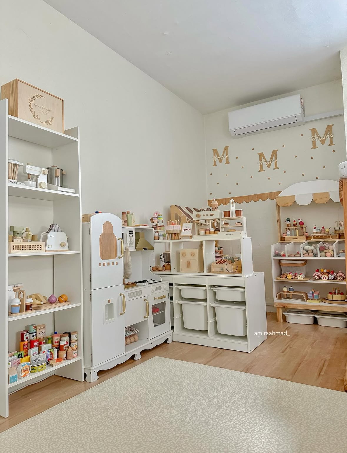 Pretend play café and kitchen area with shelves and bins for organized role-play storage.