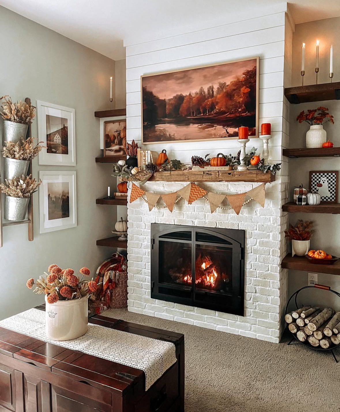 Whitewashed brick fireplace with a framed TV above the mantel