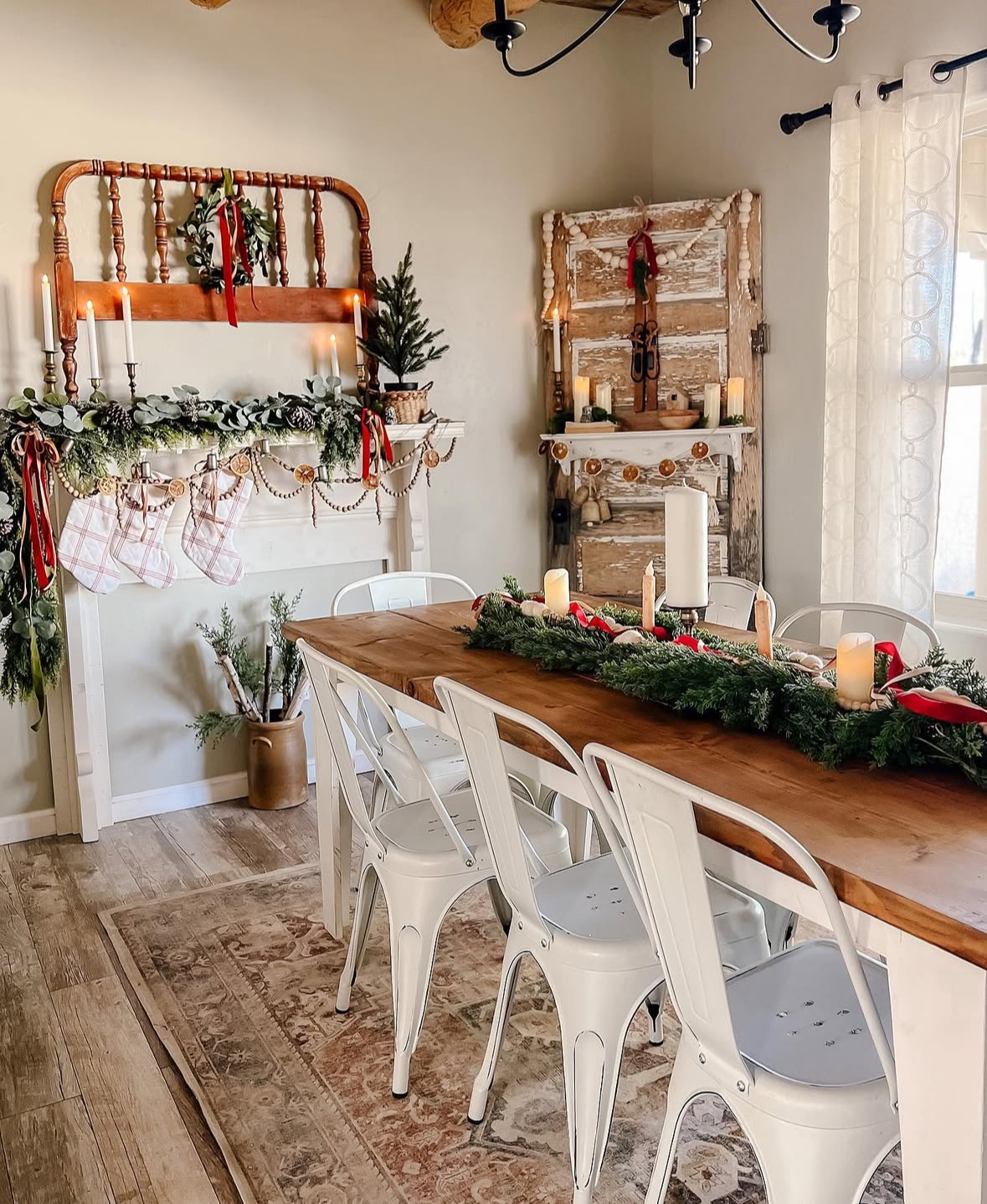 Farmhouse mantel with stockings and evergreen runner for intimate Christmas dining room ideas.