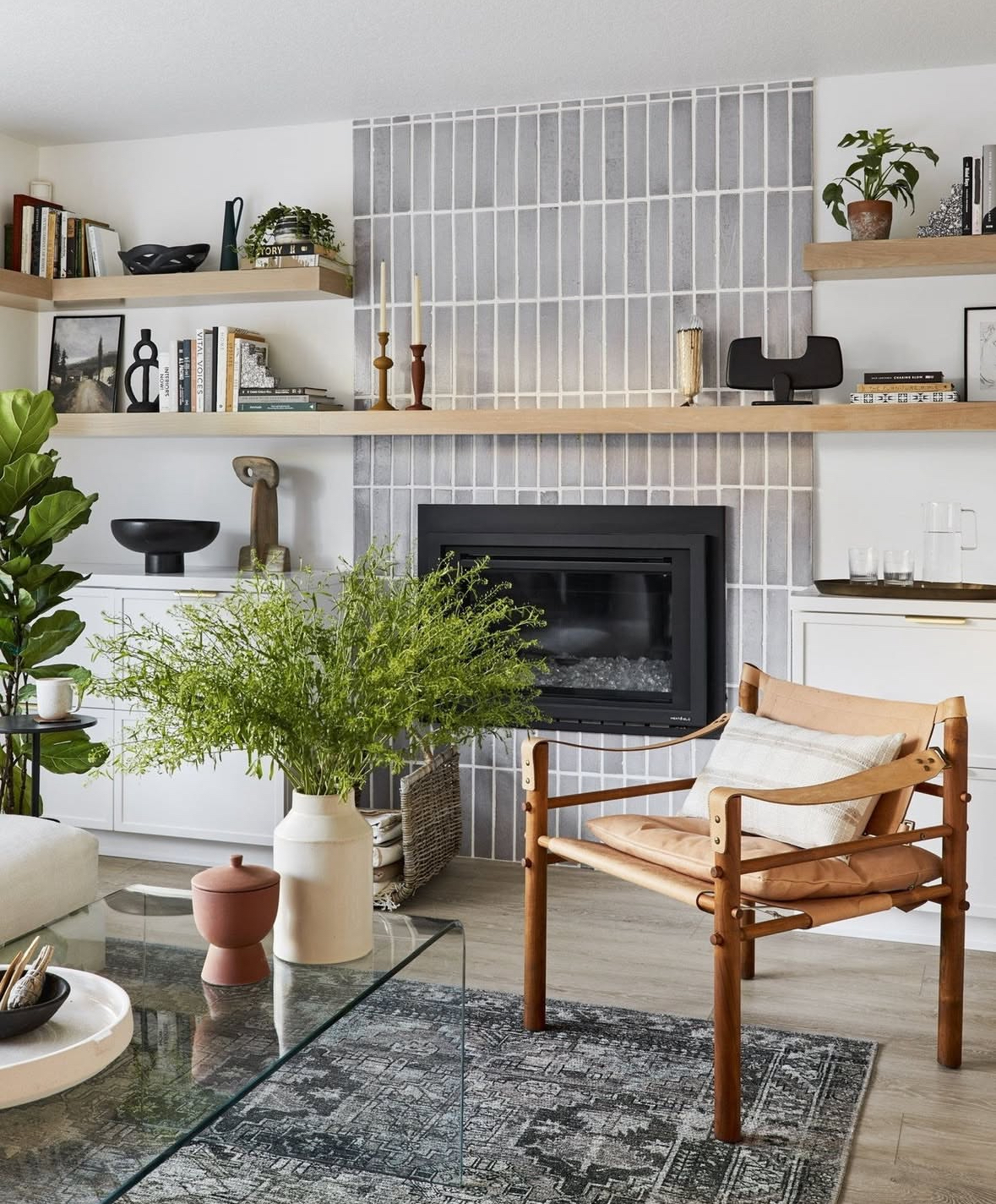 Vertical tile fireplace surround paired with warm wood accents