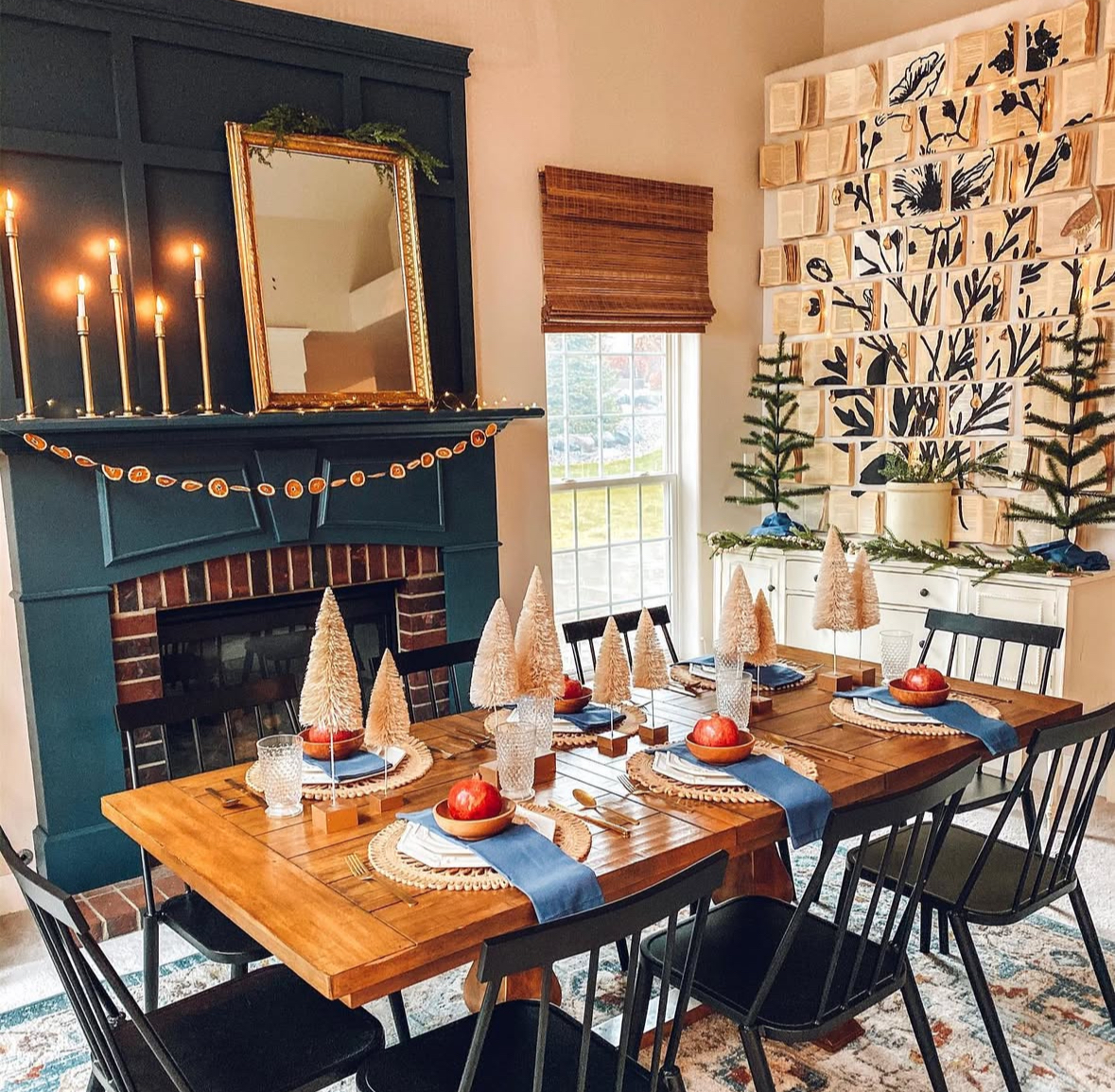 Teal mantel, dried orange garland, and bottle-brush forest for cozy Christmas dining room ideas.