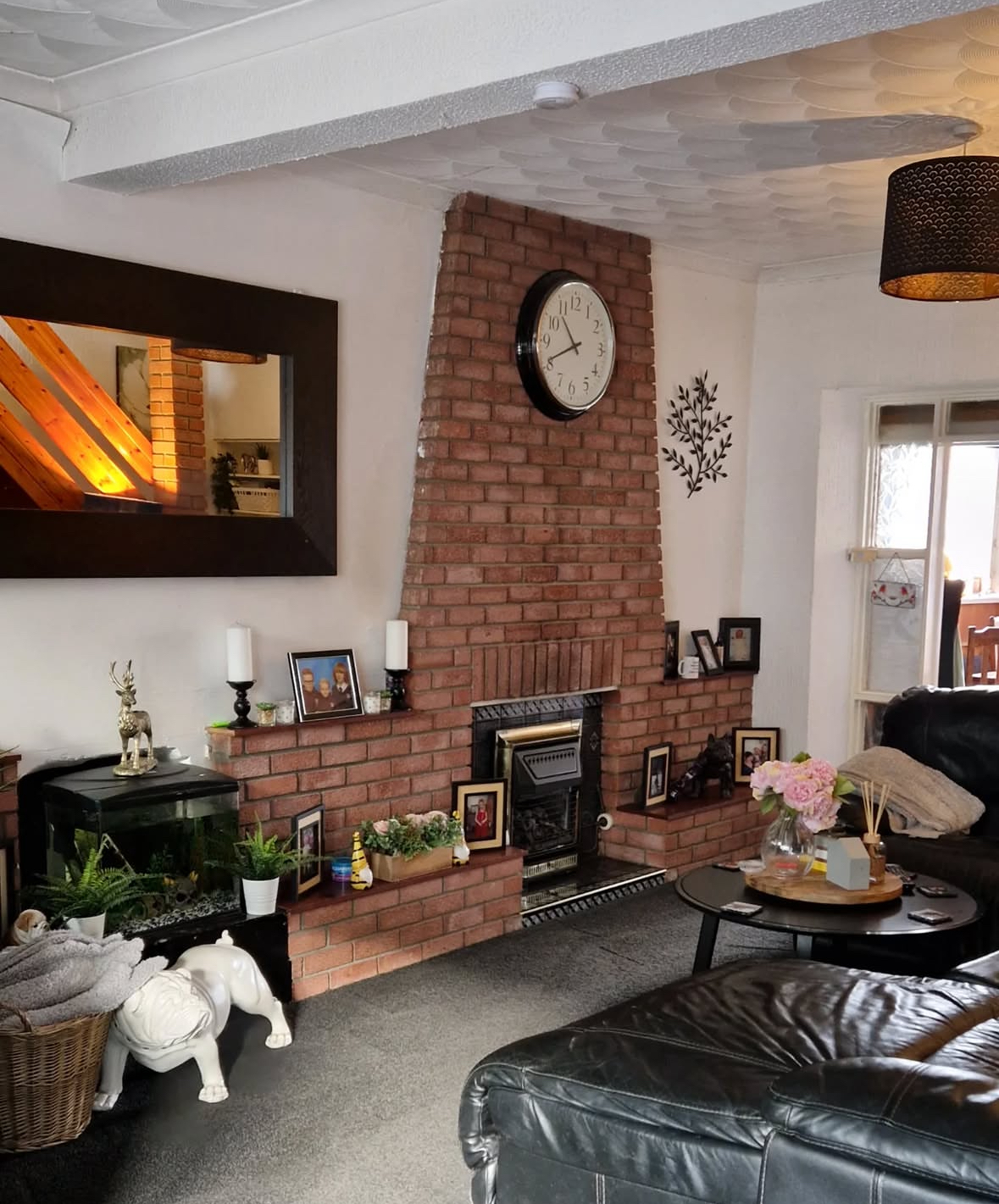 Red brick fireplace tucked into a triangular architectural nook