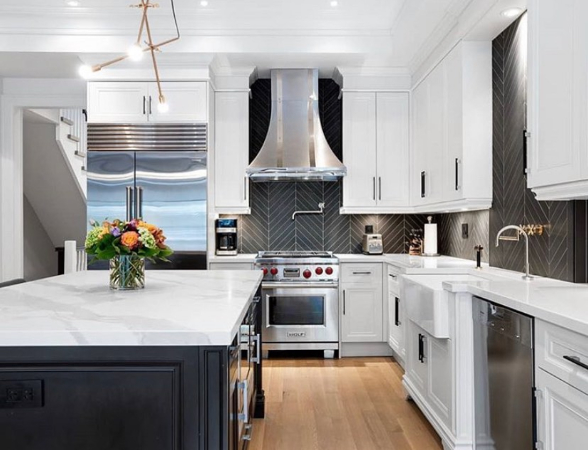 Traditional white kitchen featuring a black chevron tile backsplash